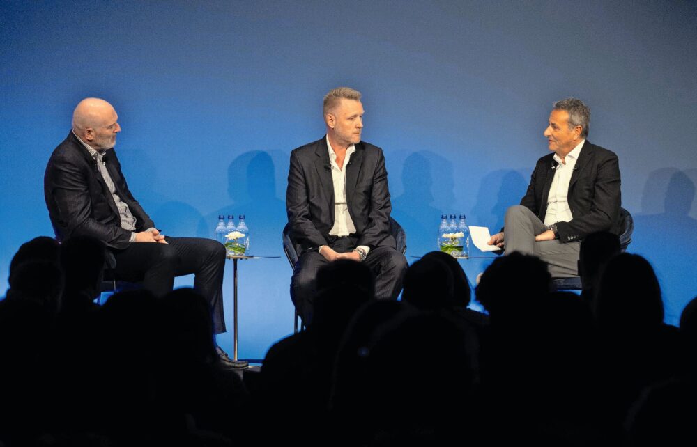 In conversation on the podium at Oracle Cloud World on March 27 in Zurich: Cormac Watters, Executive Vice President and General Manager, EMEA Applications (Oracle, left), with Michael Fuchs (CFO Lemo, center) and Isidorie Chirichiello (CIO Lemo, right). © Oracle